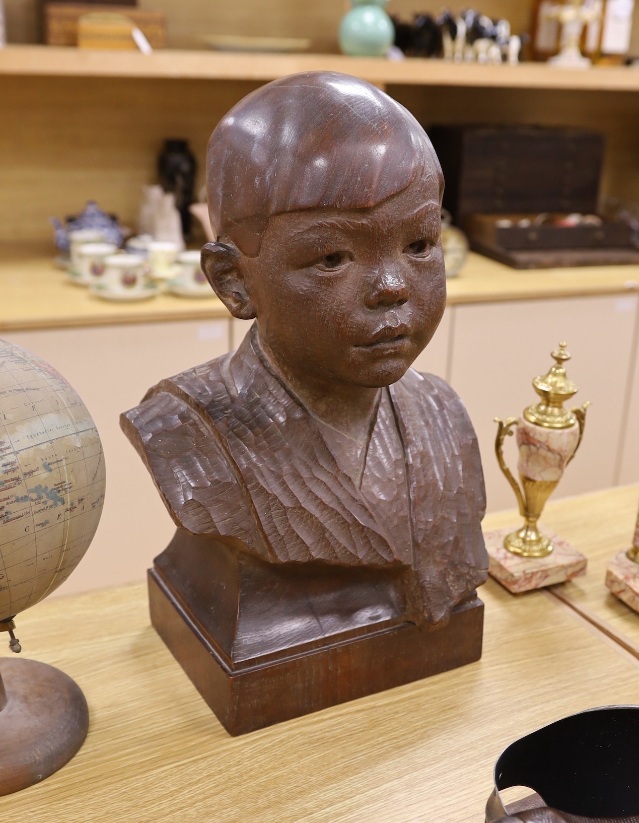 George Henry Paulin (1888-1962), a carved walnut bust of a young Japanese boy, 48cm tall